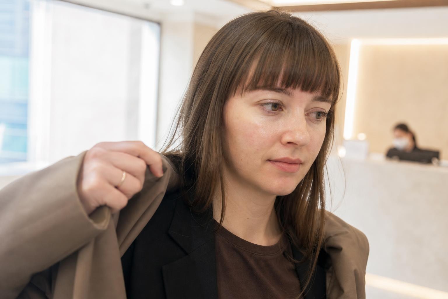 A woman in her thirties with a sealed vial being shown to her before a skin booster treatment in a Gangnam clinic